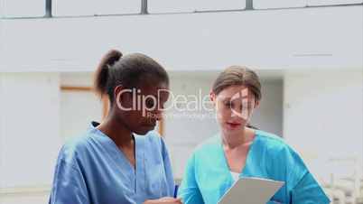 Doctor showing a clipboard to a nurse