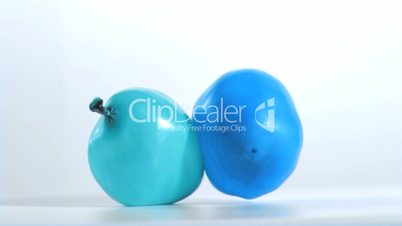 Two balloons falling in super slow motion