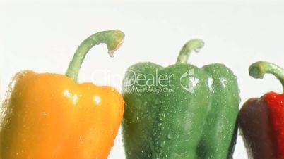 Peppers in super slow motion receiving water