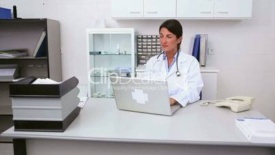 Smiling doctor in her office with patient