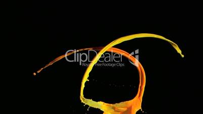 Yellow and orange paint in super slow motion splashing