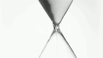 Sand flowing in super slow motion from an egg timer
