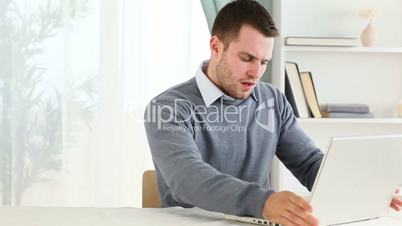 Stressed man working on a laptop