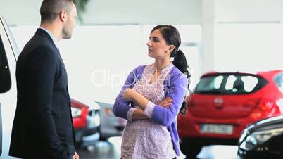 Businessman giving car keys while shaking hands