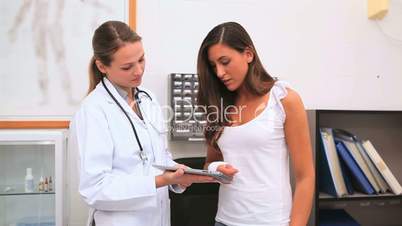 Doctor showing a tablet computer to a patient