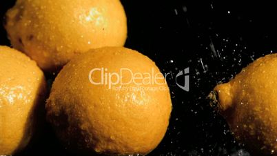 Lemons in super slow motion receiving water