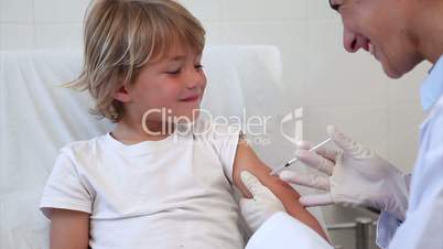 Doctor giving to a child an injection