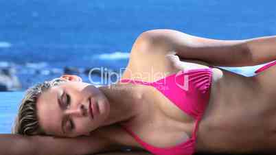 Woman lying on side while tanning