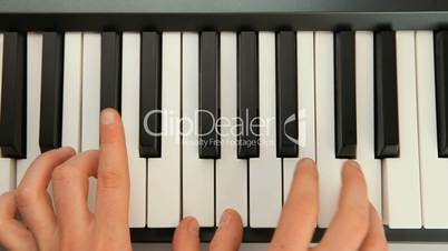 Fingers typing on piano keys