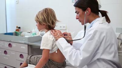 Doctor examining the breathing of a child