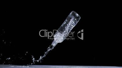 Water spilling out in super slow motion from a bottle
