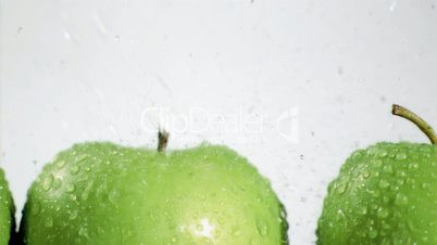 Water drops falling in super slow motion on apples