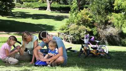 Family sitting while talking in a park