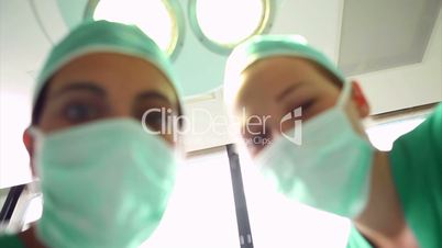 Surgeons above a patient