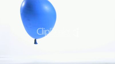 Blue balloon rebounding in super slow motion