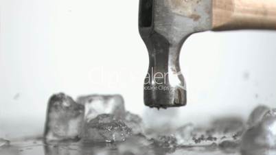 Hammer in super slow motion crushing ice cubes