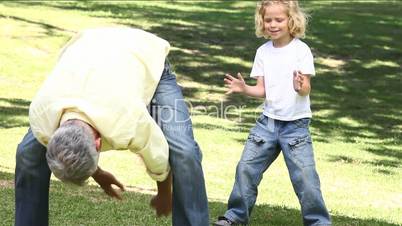 Man playing with a boy in a park