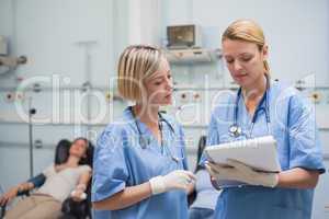 Nurses looking at a clipboard