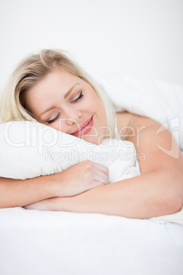 Young woman smiling while sleeping