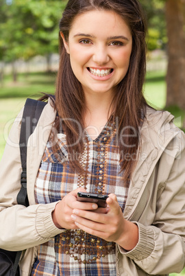 Portrait of a cute teenager with a smartphone
