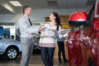 Smiling salesman talking with a woman
