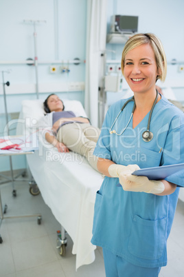 Smiling nurse next to a transfused patient