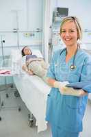 Smiling nurse next to a transfused patient