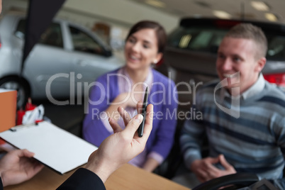 Couple listening to a car dealer