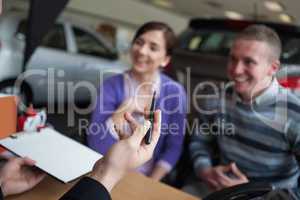 Couple listening to a car dealer