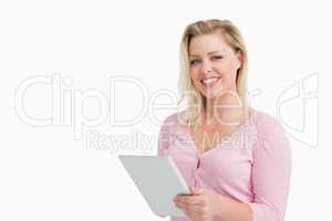 Cheerful blonde woman holding her touchscreen