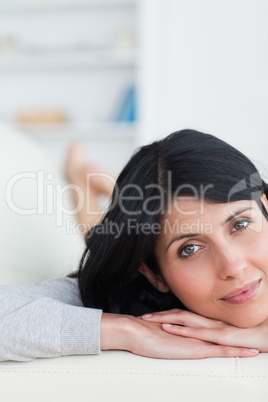 Close-up of a woman resting her head on a sofa