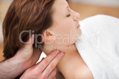 Therapist massaging the neck of woman while holding her head