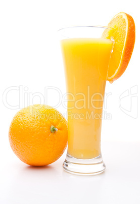 Orange near a glass of orange juice