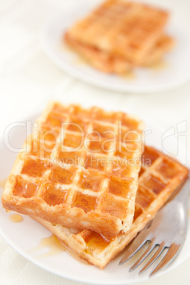 Waffles spread with honey in a plateful