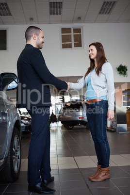 Dealer shaking hand of a woman