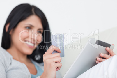 Woman holding a tactile tablet and a credit card