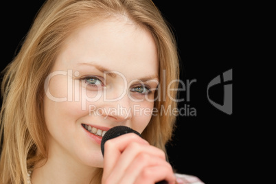 Young woman smiling while singing