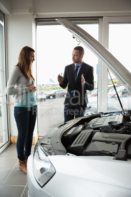 Businessman presenting a car to a woman