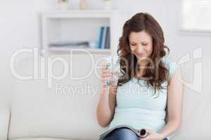 Woman reading a magazine while sitting on a sofa