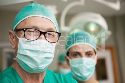Smiling surgeon crossing his arms with a colleague