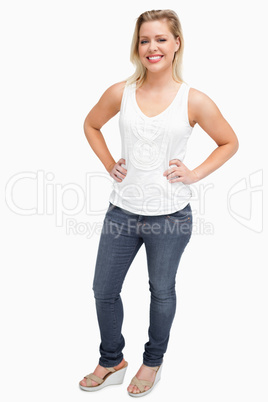 Smiling blonde woman placing her hands on her hips