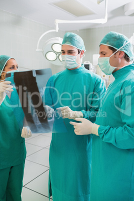 Close up of a surgical team examining a X-ray