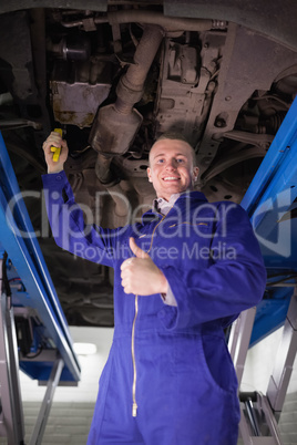 Man repairing a car with an adjustable pliers