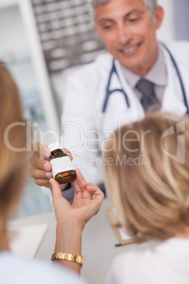 Doctor giving a bottle of drugs