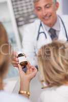 Doctor giving a bottle of drugs