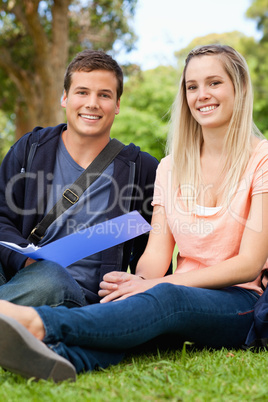 Portrait of a smiling tutor helping a teenager to revise