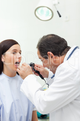Doctor auscultating the mouth of his patient