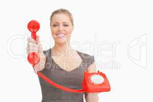 Woman showing a red retro phone