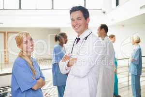 Doctor in front of a nurse with arms crossed