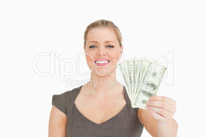 Smiling woman showing dollars banknotes